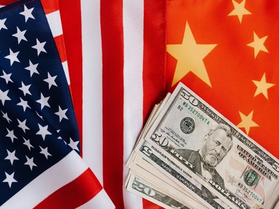 Chinese and American flags with dollar bills